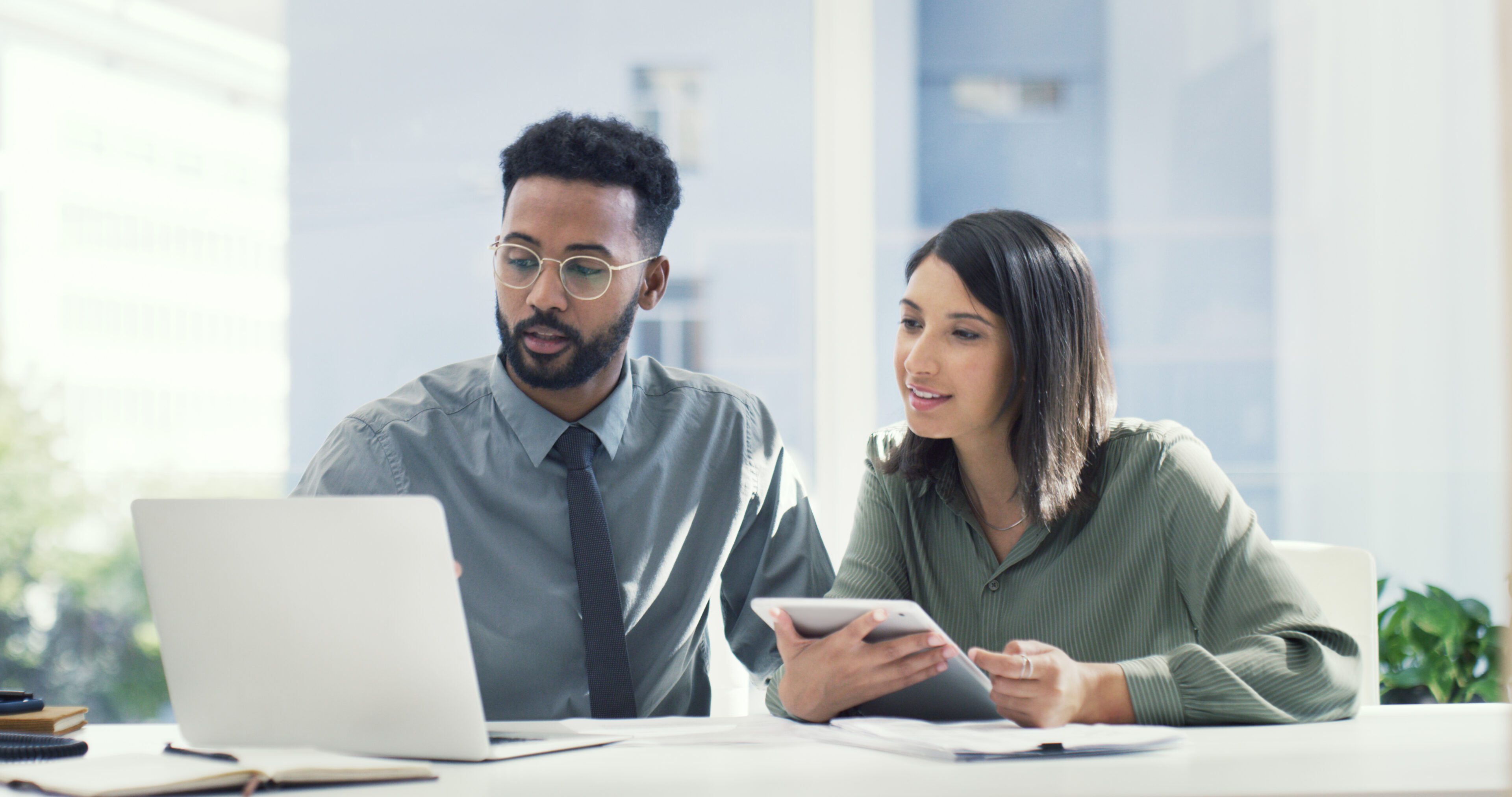 Technology helps boost our chances of success when collaborating Shot of two businesspeople having a discussion while looking at a laptop