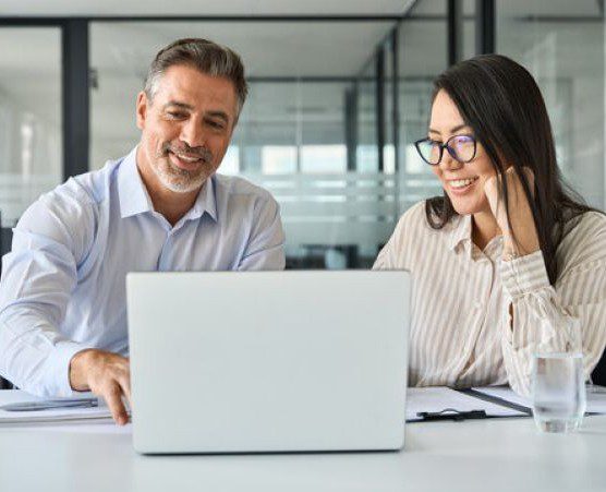 Man and Woman Looking at Laptop 556 X 451